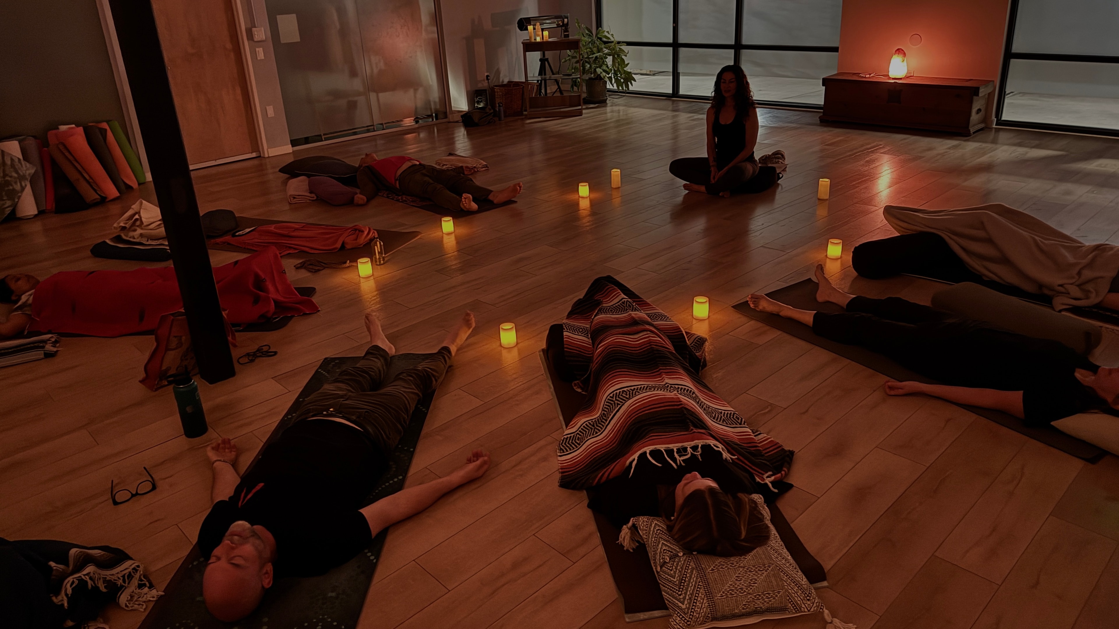 Abby Craden leading a Yoga Nidra class by candlelight